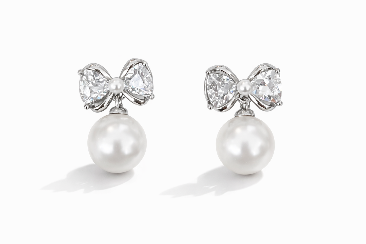 Crystal bow and pearl pendant earrings