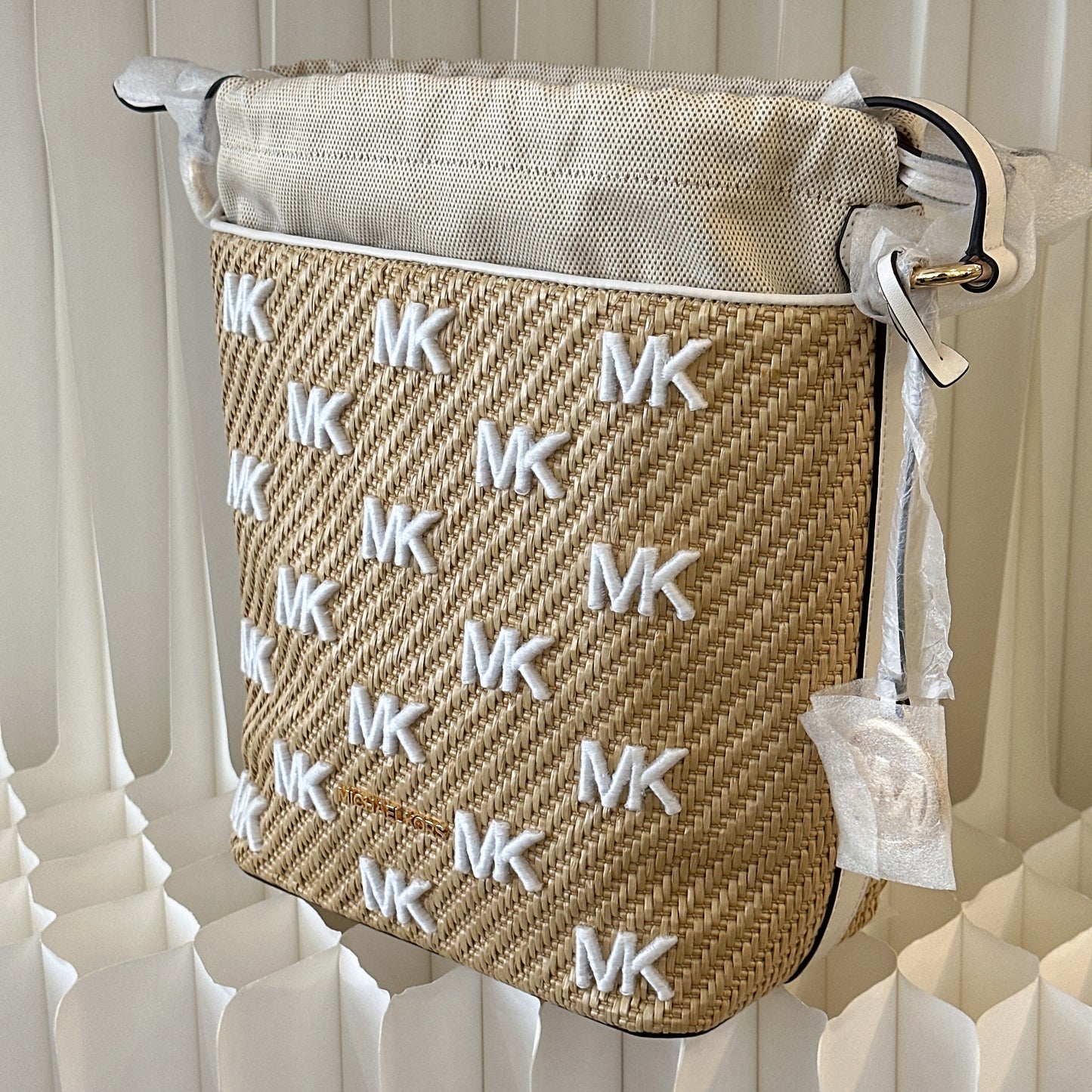 Michael Kors Eden straw drawstring bucket bag.