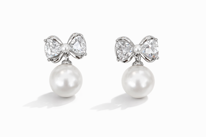 Crystal bow and pearl pendant earrings