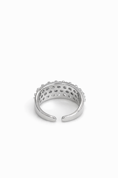 Three rows of diamond-encrusted open rings