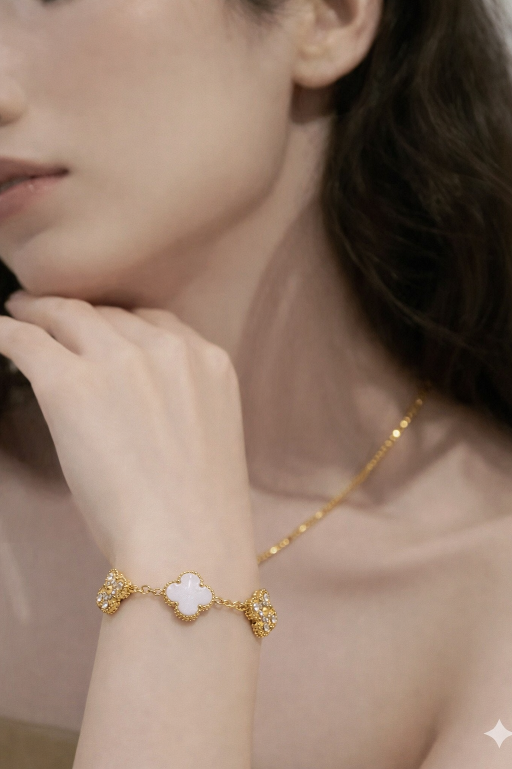 A four-leaf clover gold bracelet inlaid with white mother-of-the-shell