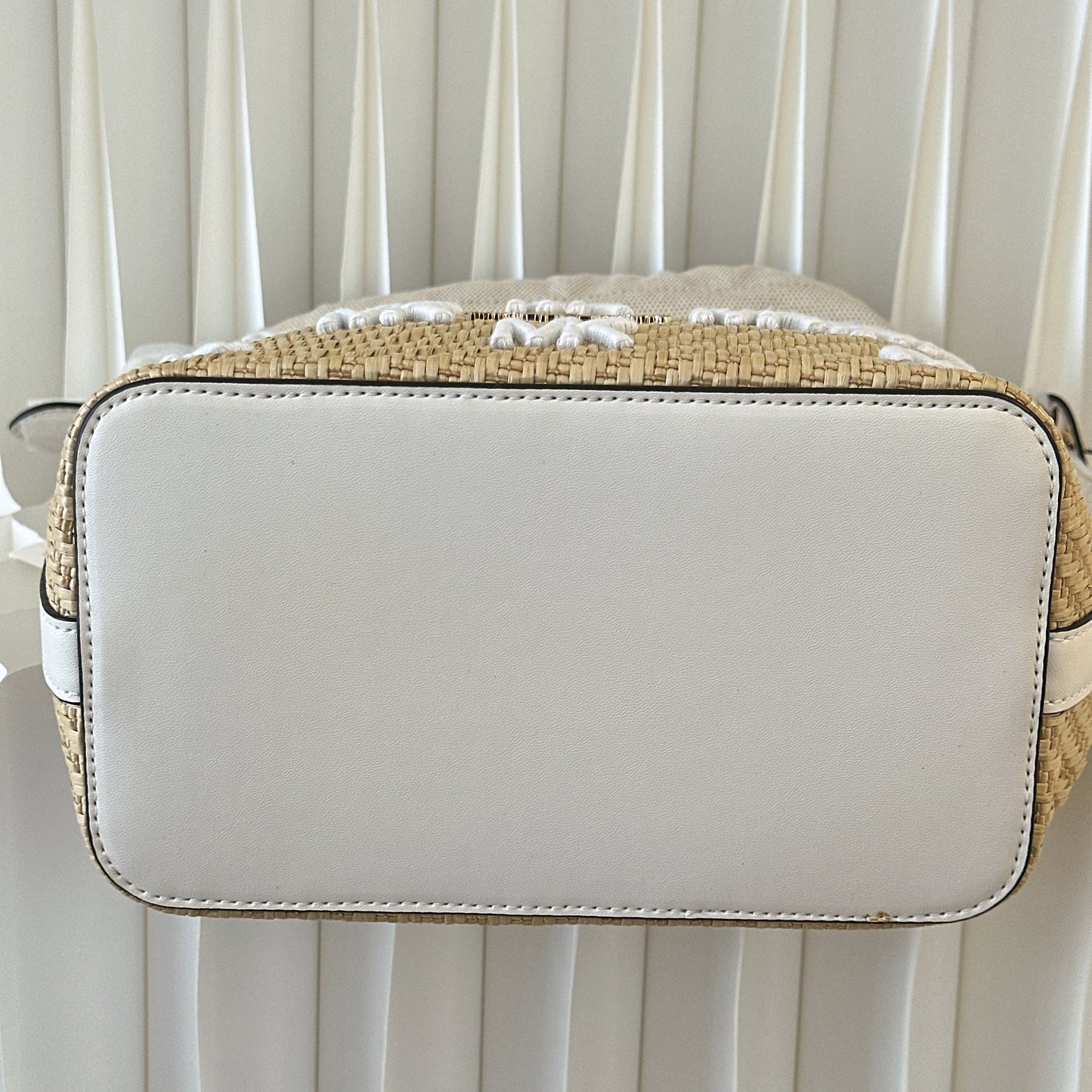 Michael Kors Eden straw drawstring bucket bag.