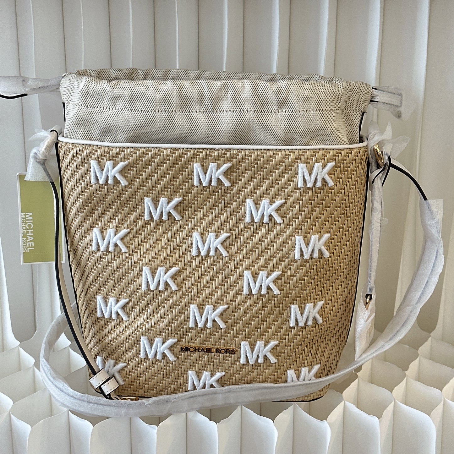 Michael Kors Eden straw drawstring bucket bag.