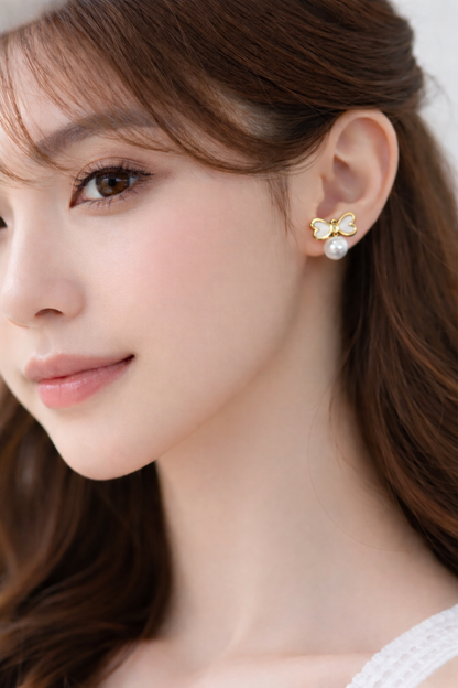 Gold bow pearl earrings