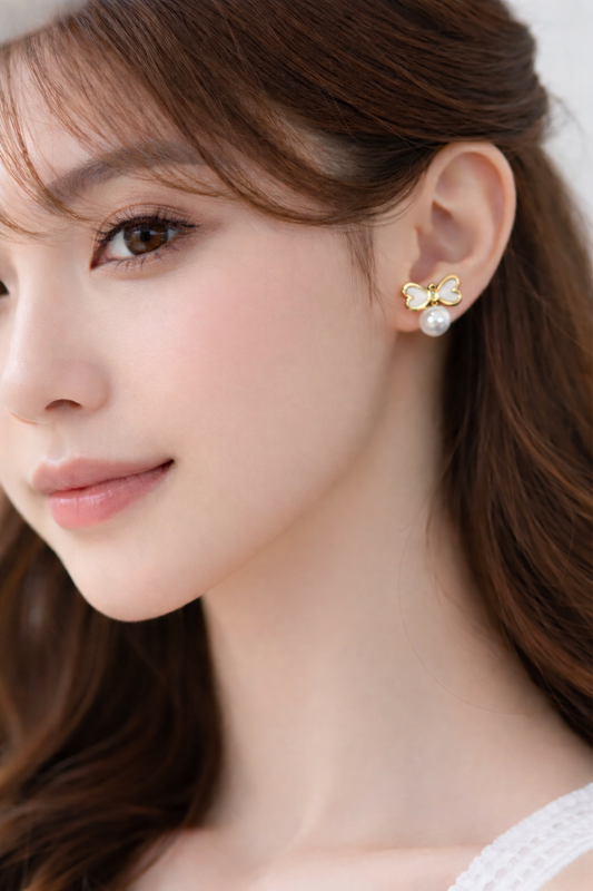 Gold bow pearl earrings
