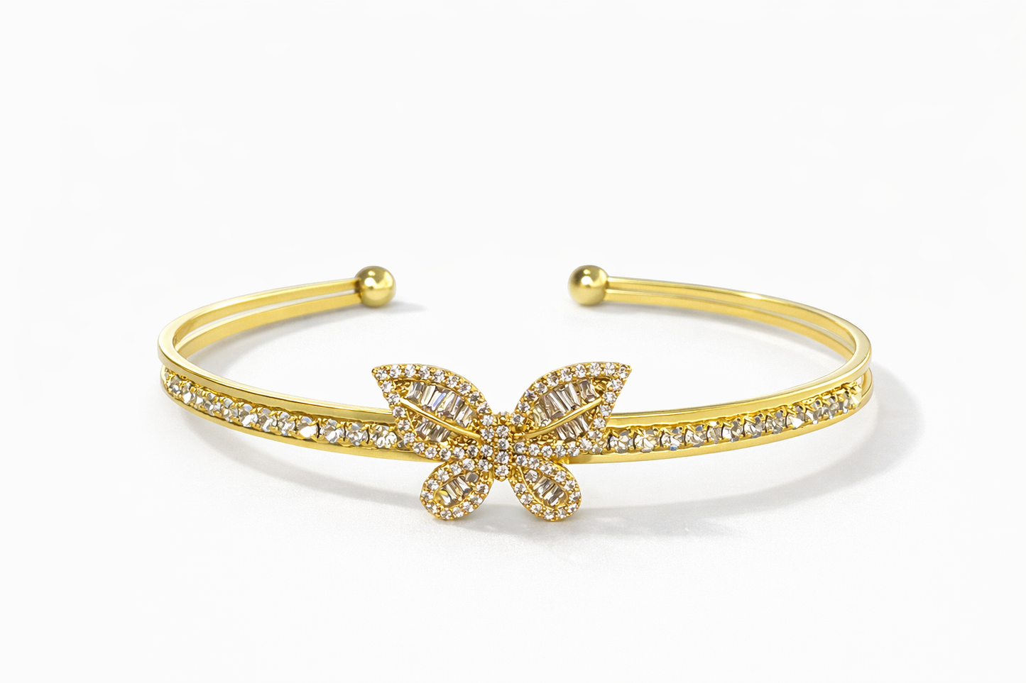 Golden open bracelet decorated in a butterfly shape